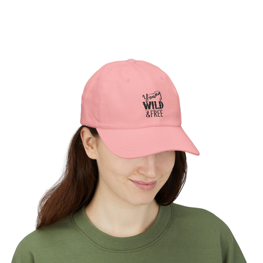 Person wearing a pink cap with 'Young, Wild & Free' text on a white background