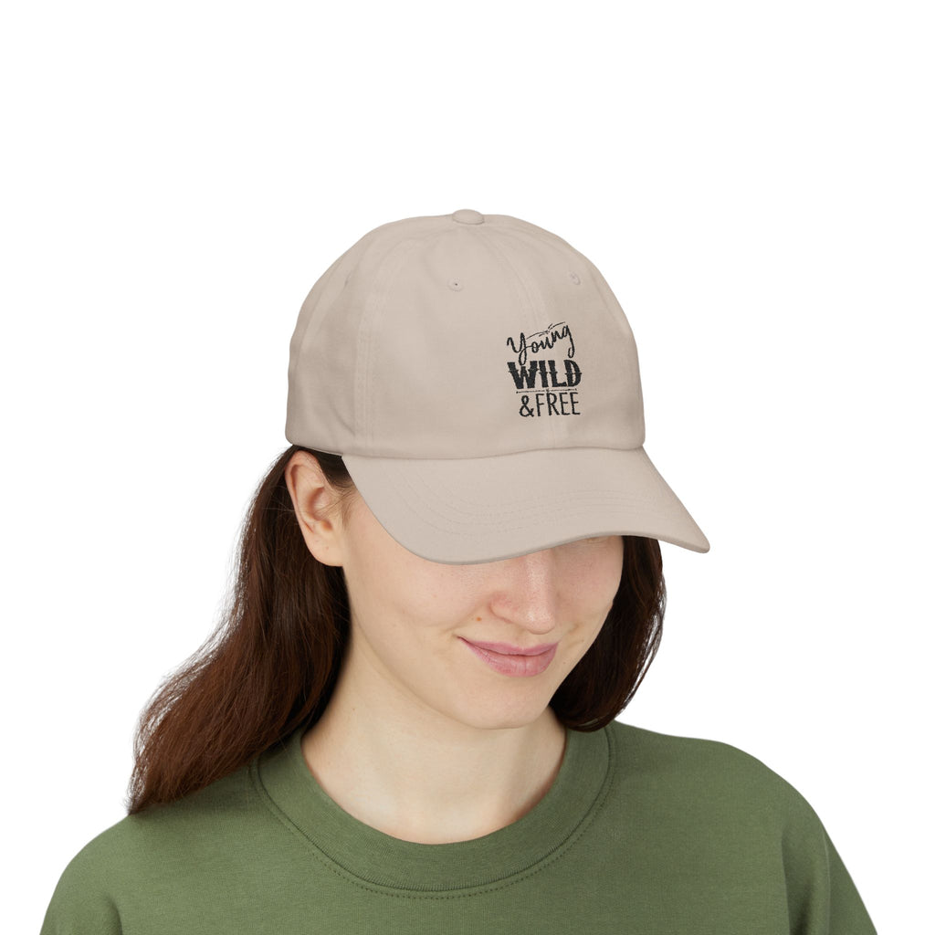 Person wearing a beige cap with 'Young Wild & Free' text on a white background