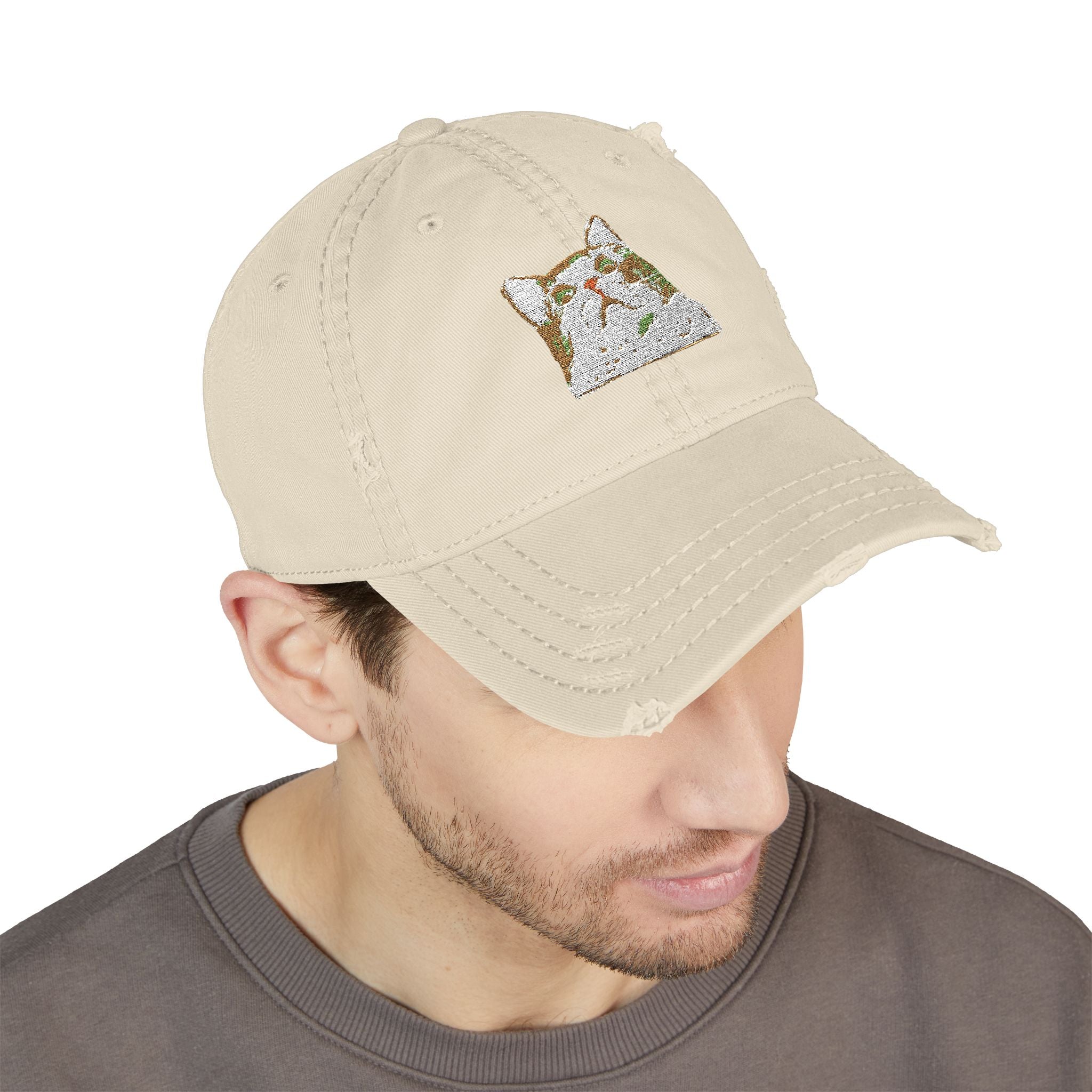 Beige cap with a logo worn by a person on a white background
