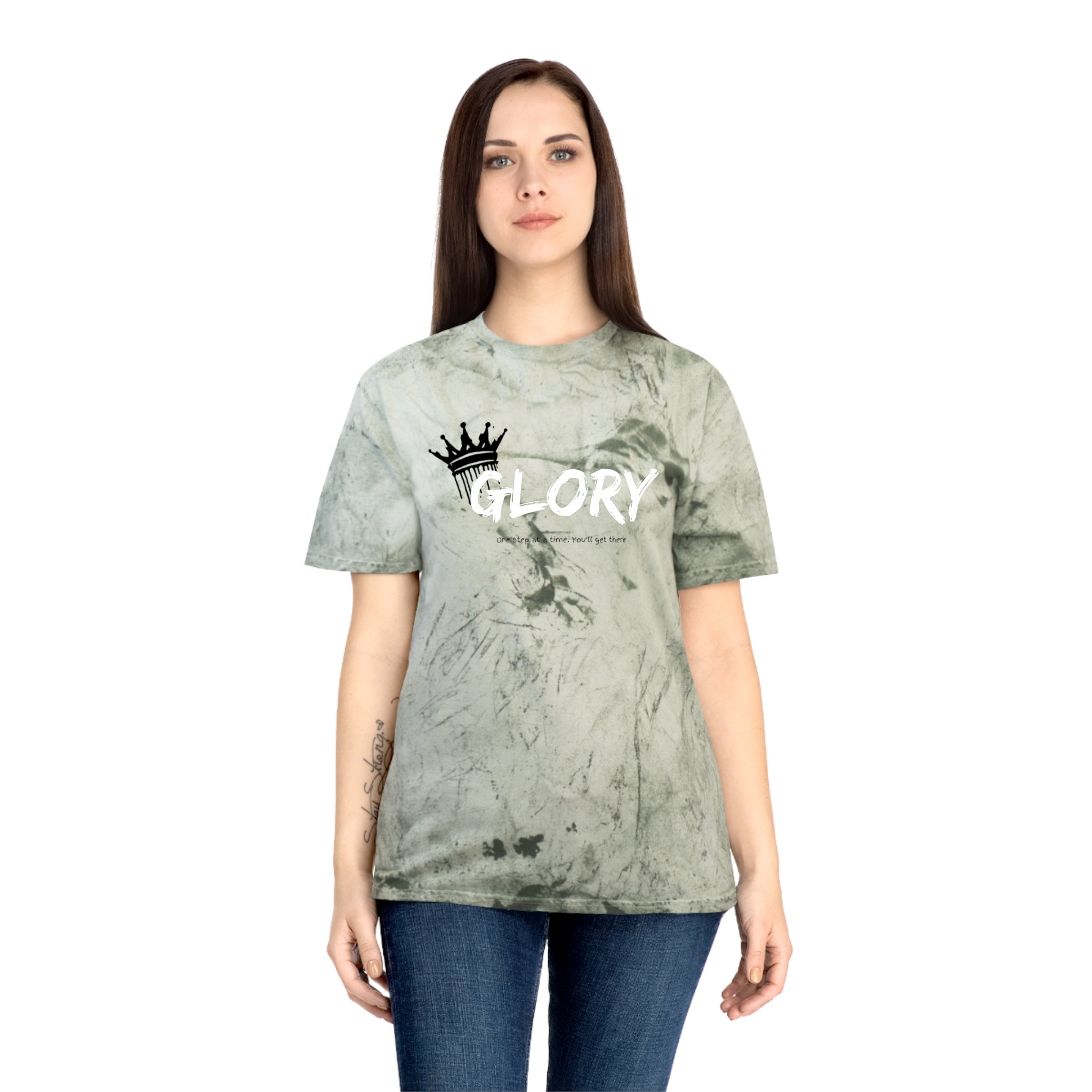 Person wearing a green tie-dye t-shirt with 'GLORY' text and crown graphic on a white background