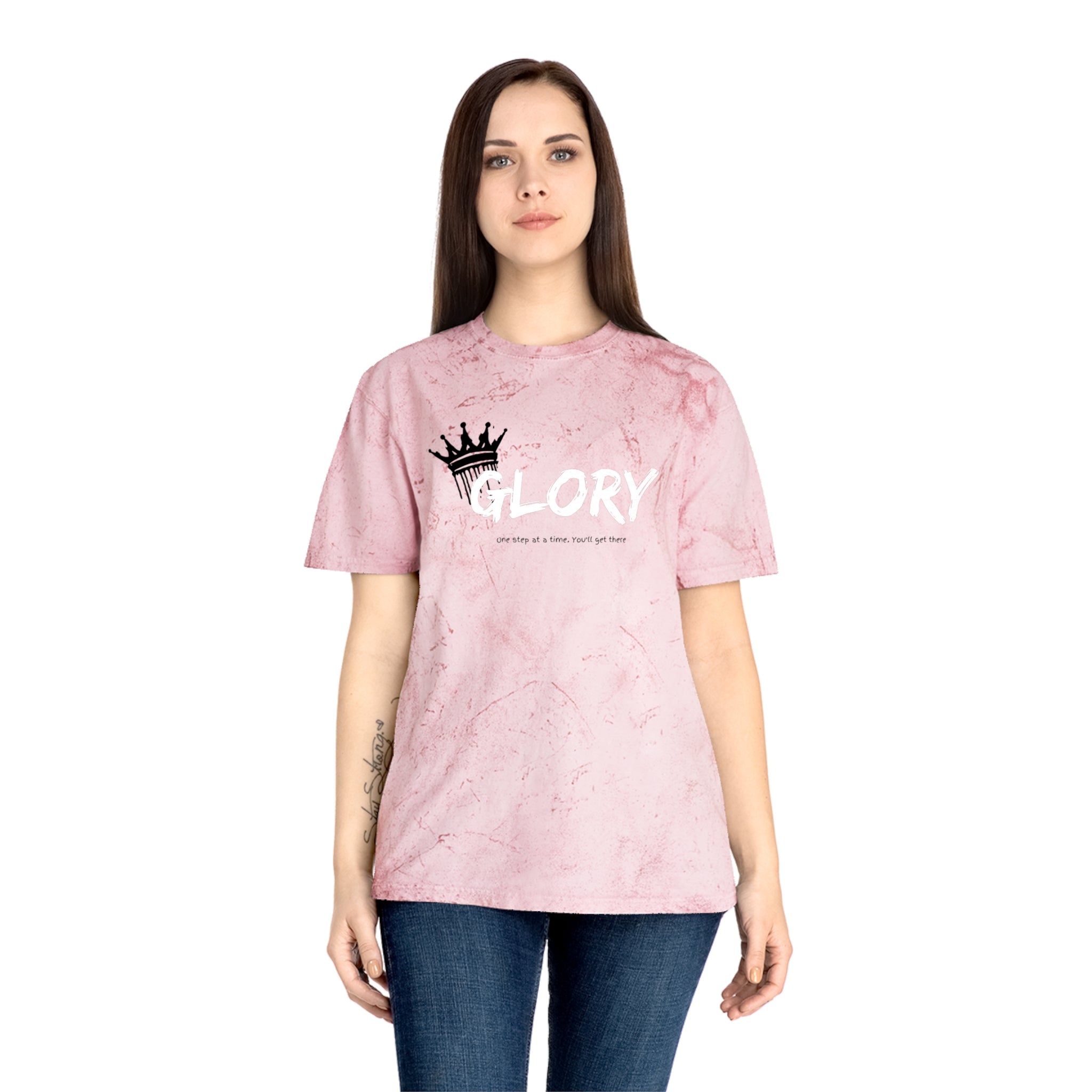 Person wearing a pink t-shirt with 'GLORY' printed on it against a white background