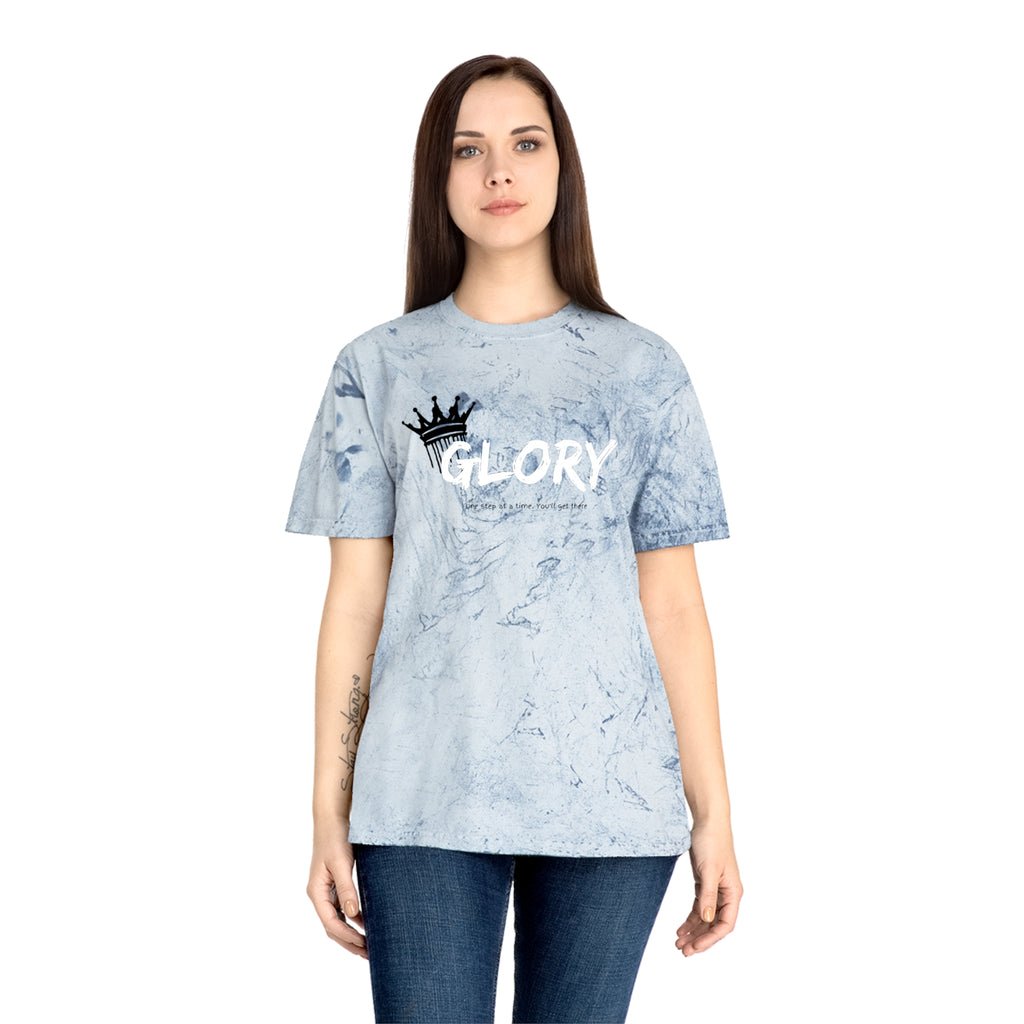Person wearing a light blue tie-dye t-shirt with 'GLORY' printed on it against a white background