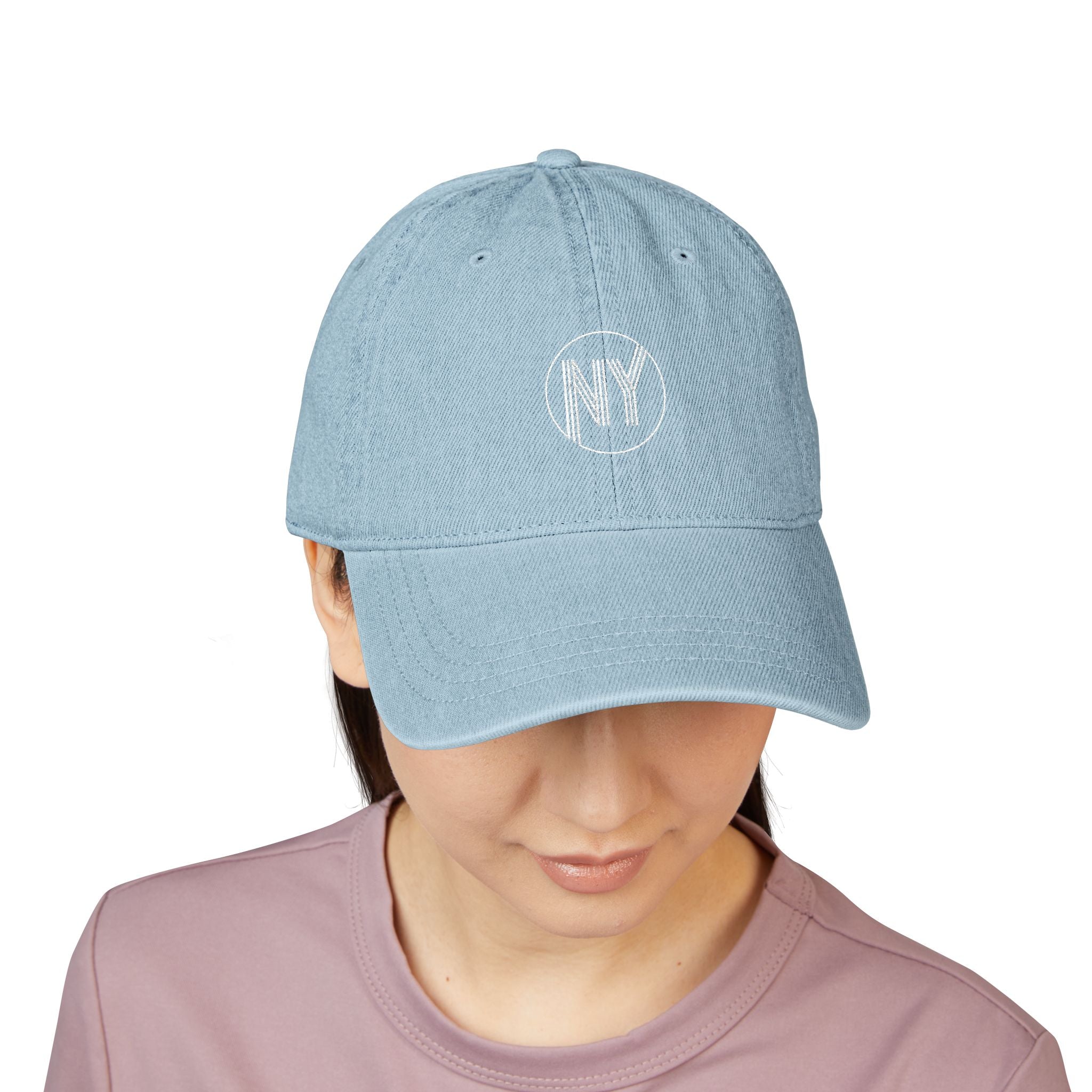 Light blue cap with 'NY' logo worn by a person on a white background