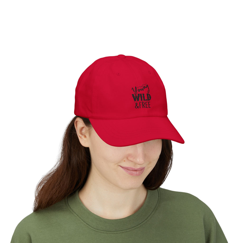 Person wearing a red cap with 'Young, Wild & Free' text on a white background