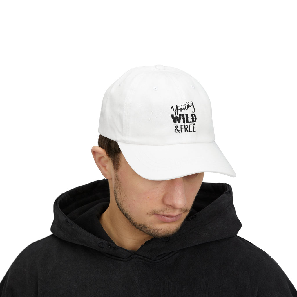 Person wearing a white cap with 'Young Wild Free' text on a white background