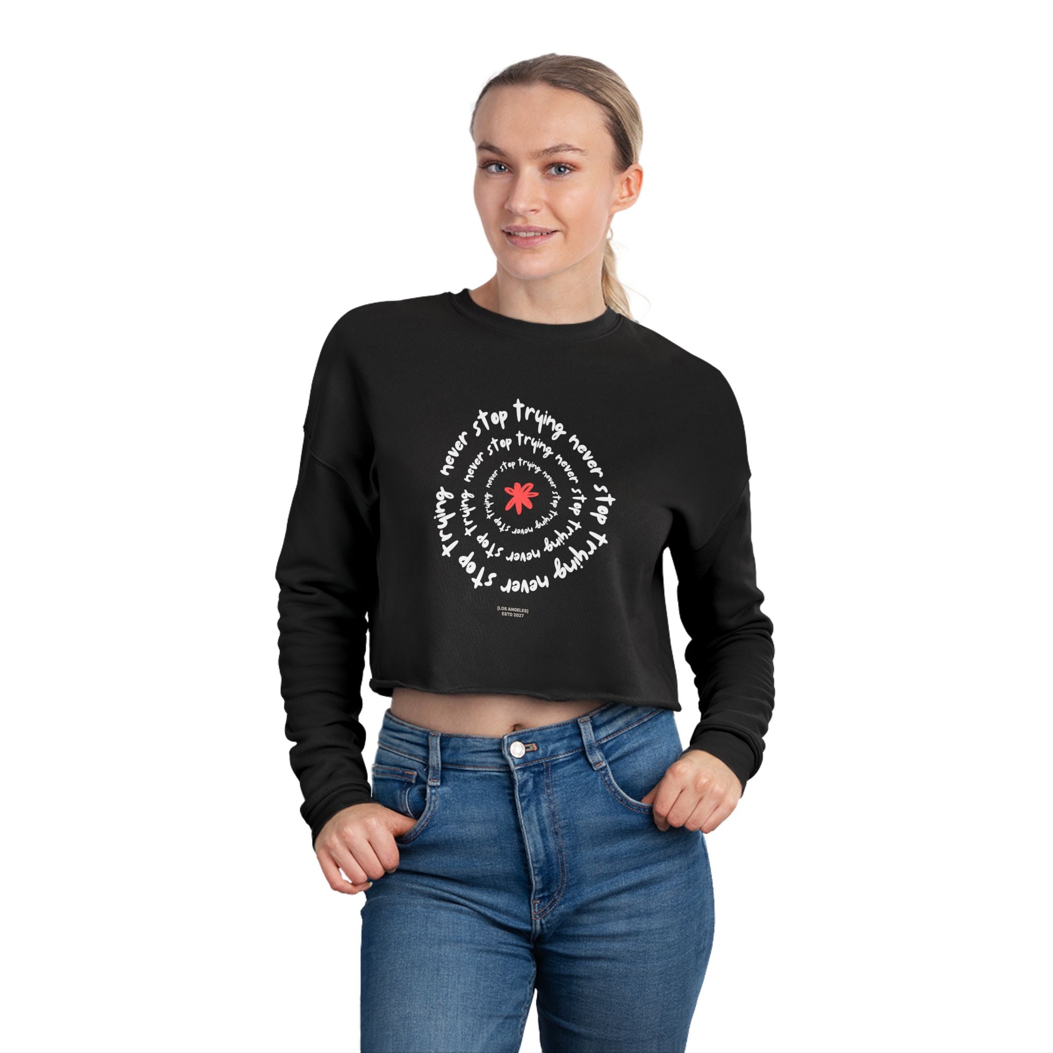 Person wearing a black cropped sweatshirt with white text design on a white background