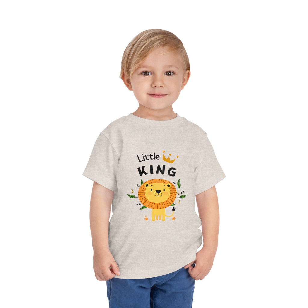 Child wearing a 'Little King' t-shirt with a lion graphic on a white background