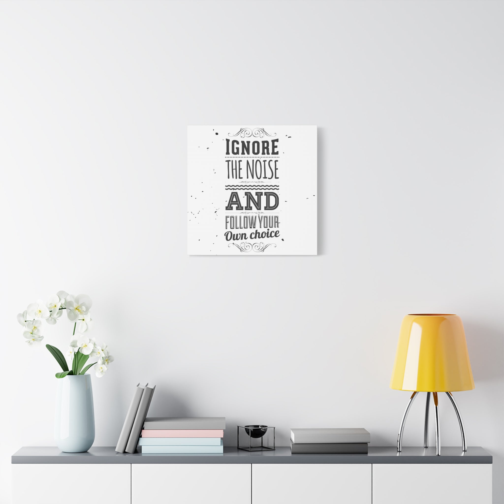 Decorative wall art with motivational quote in a modern interior setting.