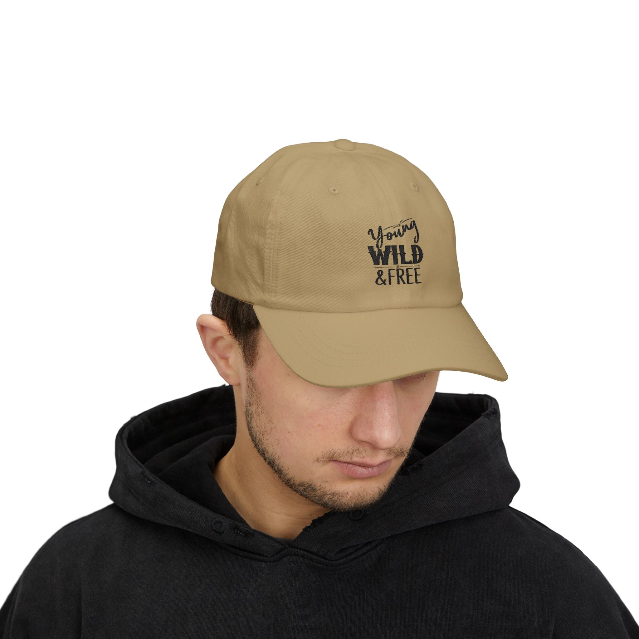 Man wearing a beige cap with 'Young Wild & Free' text on a white background