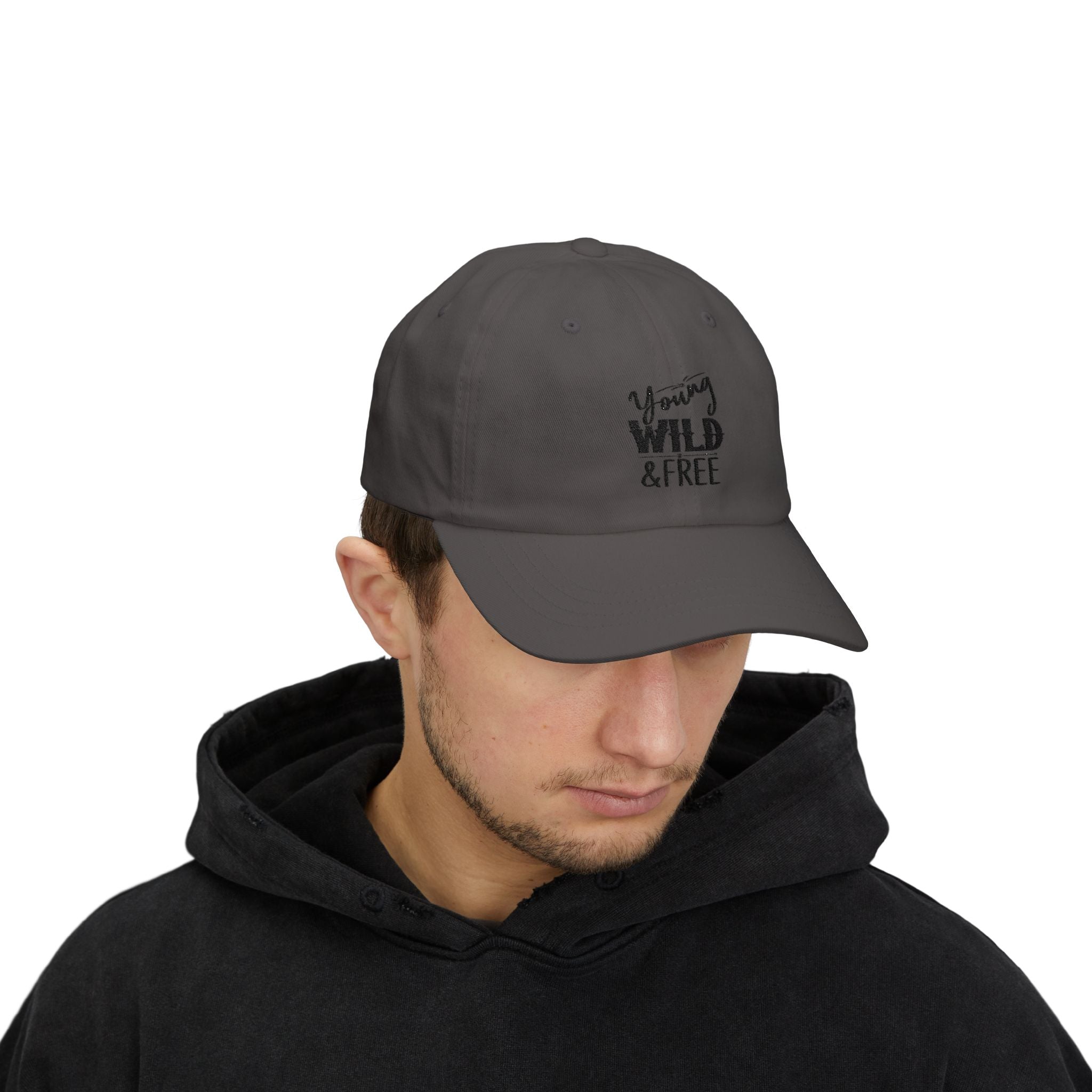 Man wearing a gray cap with 'Young Wild & Free' text on a white background