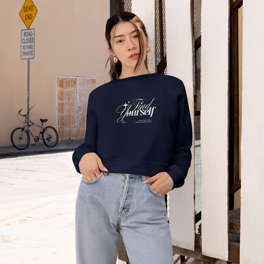 Person wearing a navy blue sweatshirt with text, standing in an urban setting.