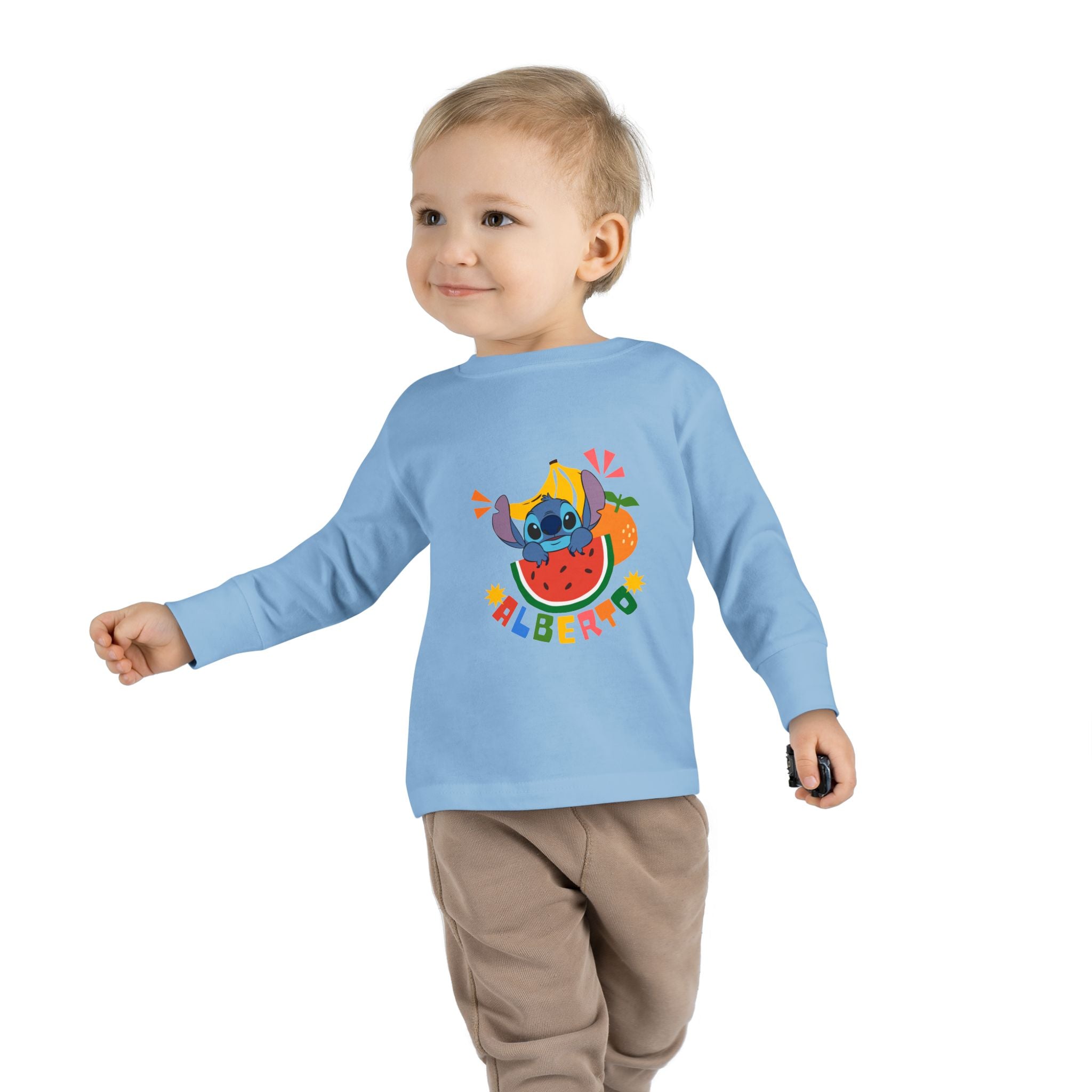 Child wearing a light blue long-sleeve shirt with a colorful design on a white background