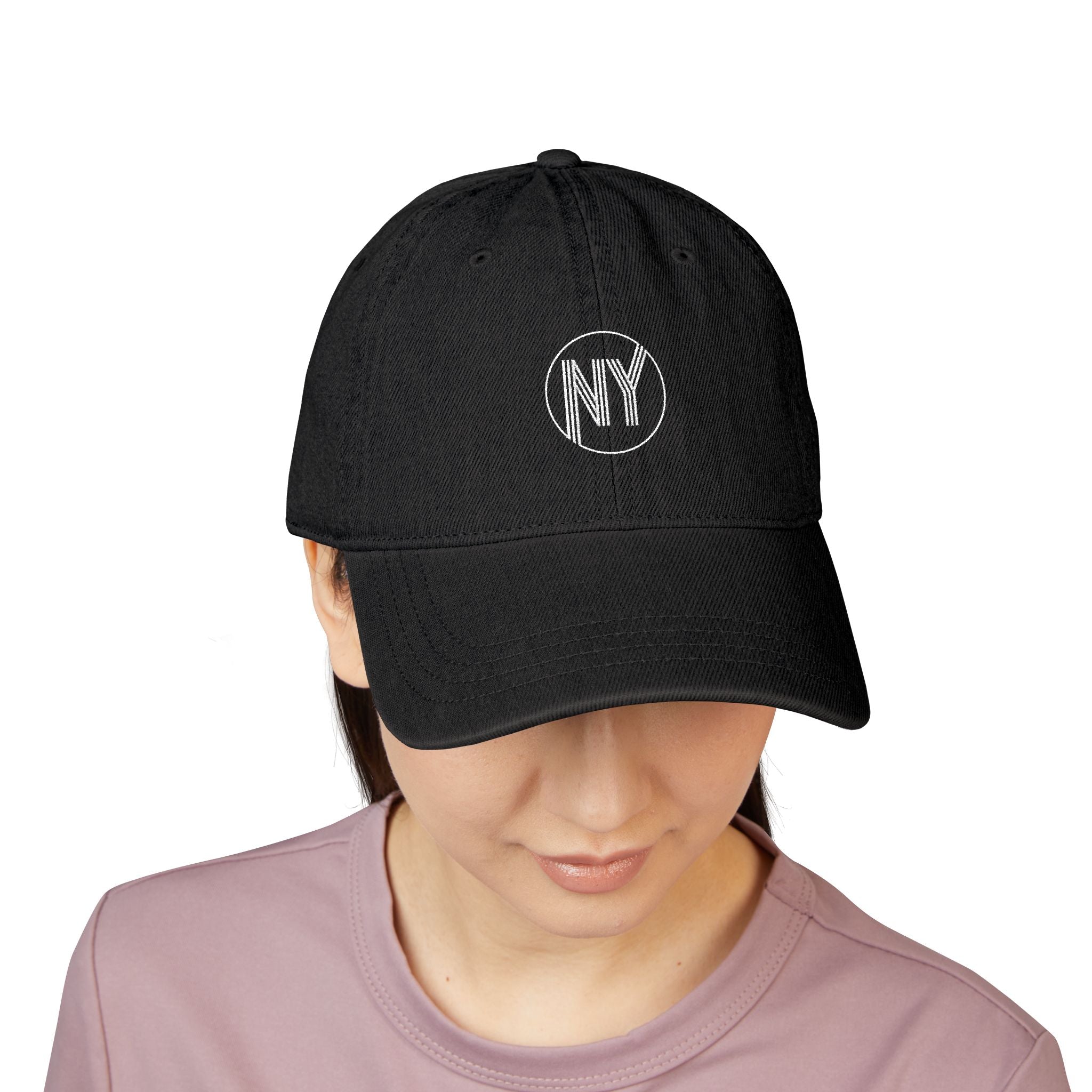 Black cap with 'NY' logo worn by a person on a white background