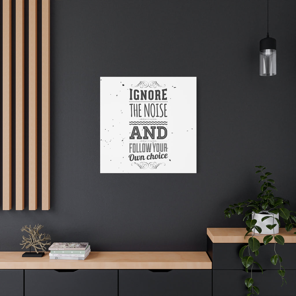 Framed poster with motivational quote on a dark wall above a wooden shelf.