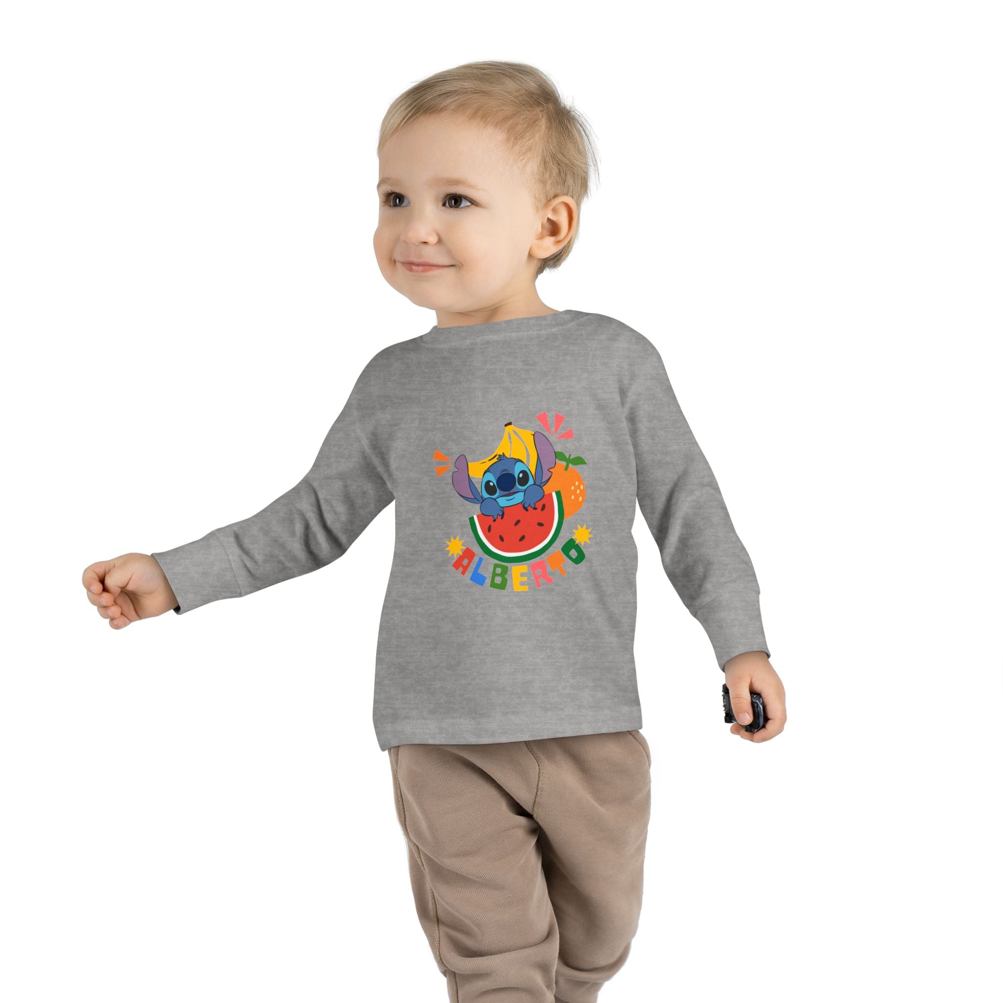 Child wearing a gray long-sleeve shirt with a colorful design on a white background