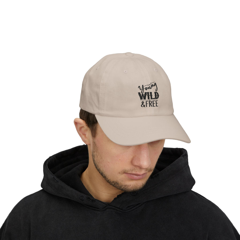 Man wearing a beige cap with 'Young Wild Free' text on a white background