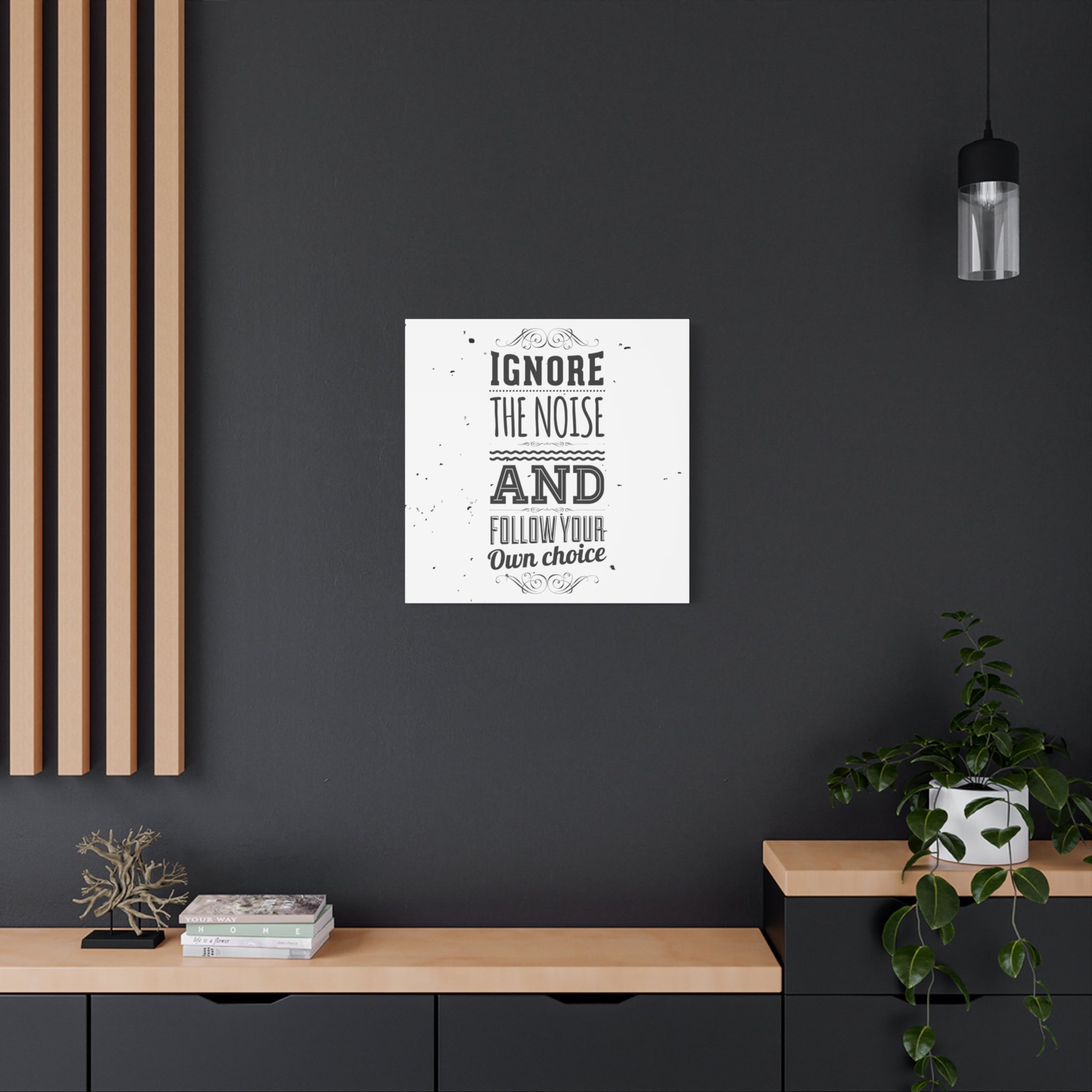 Framed poster with motivational quote on a dark wall in a modern interior setting.