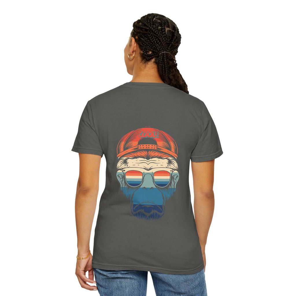 Person wearing a gray t-shirt with a graphic of a bear wearing sunglasses and a red cap on the back.