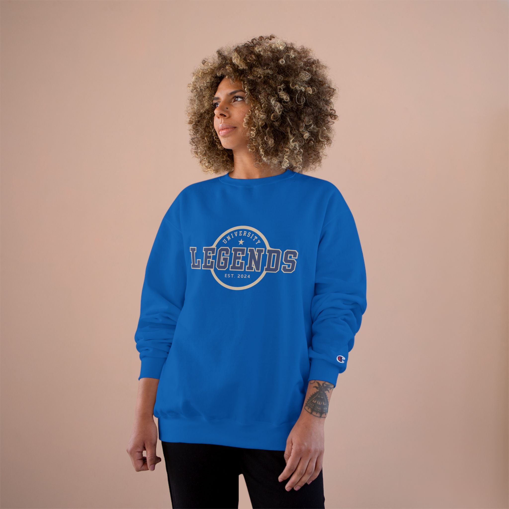 Person wearing a blue sweatshirt with 'LEGENDS' text on a beige background