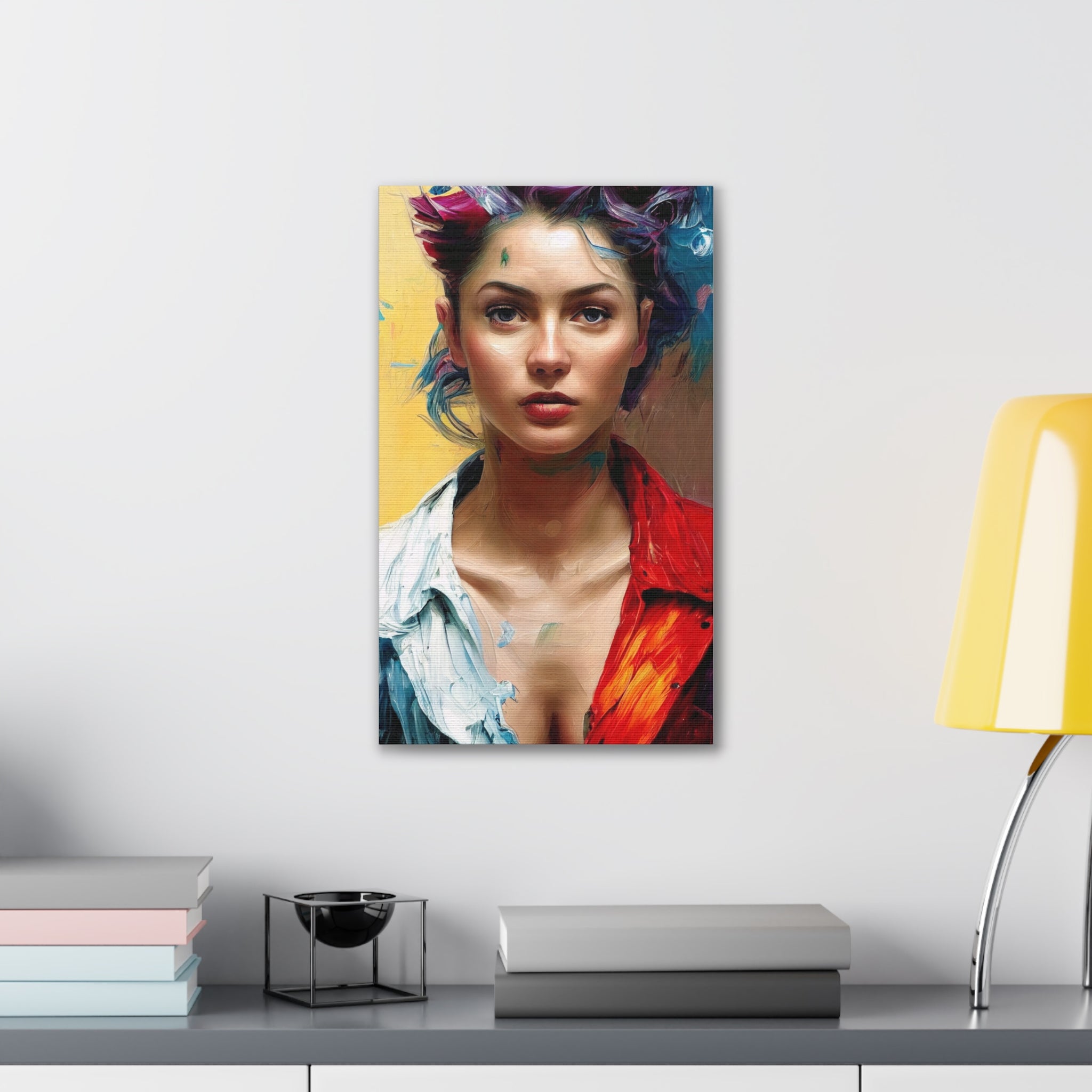 Colorful portrait of a woman on a wall above a desk with books and a lamp.